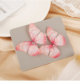 barrette en forme de papillon rose tachete